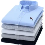 Camisas informales Oxford de algodón puro para hombre, camisa de vestir blanca de manga larga con diseño de caballo bordado, ajuste Regular, con botones a la moda