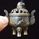 Un majestuoso portaincienso de águila que presenta un tapa con un patrón de nube hueca y un cuerpo adornado con un águila en vuelo en relieve. Este portaincienso de aleación, diseñado con tres patas, simboliza la libertad e independencia, así como la fuerza y el coraje. - Image 7